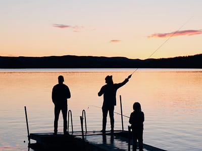 pexels-photo-988622 | Ratcliff LLP three people on a wooden fishing docks